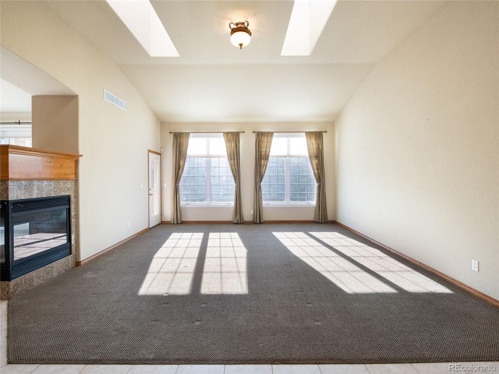 4940 West 107th Loop Westminster, CO 80031 - Photo 12 of 44 an empty room with windows