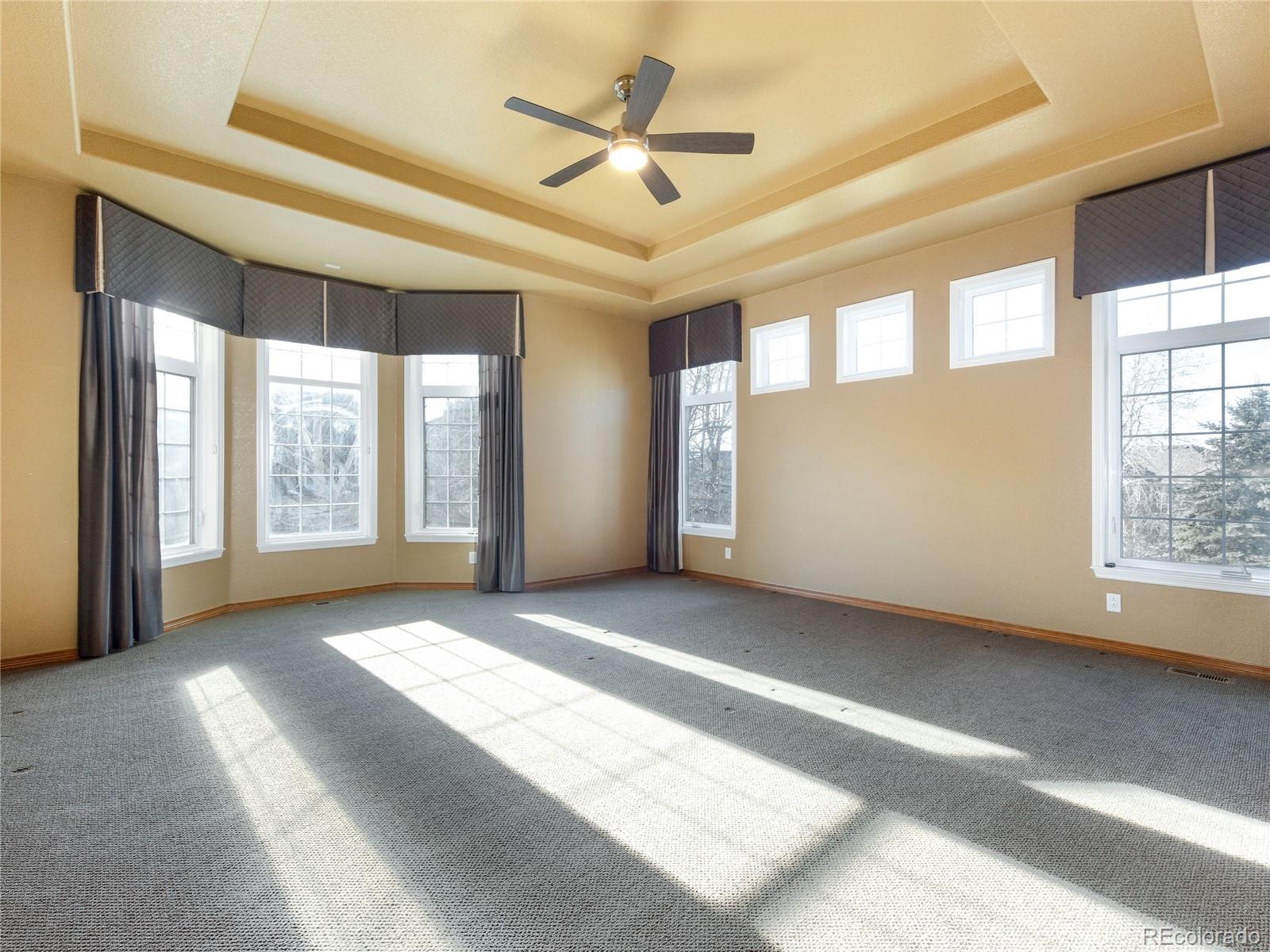 4940 West 107th Loop Westminster, CO 80031 - Photo 17 of 44 a view of an empty room with a window and a kitchen