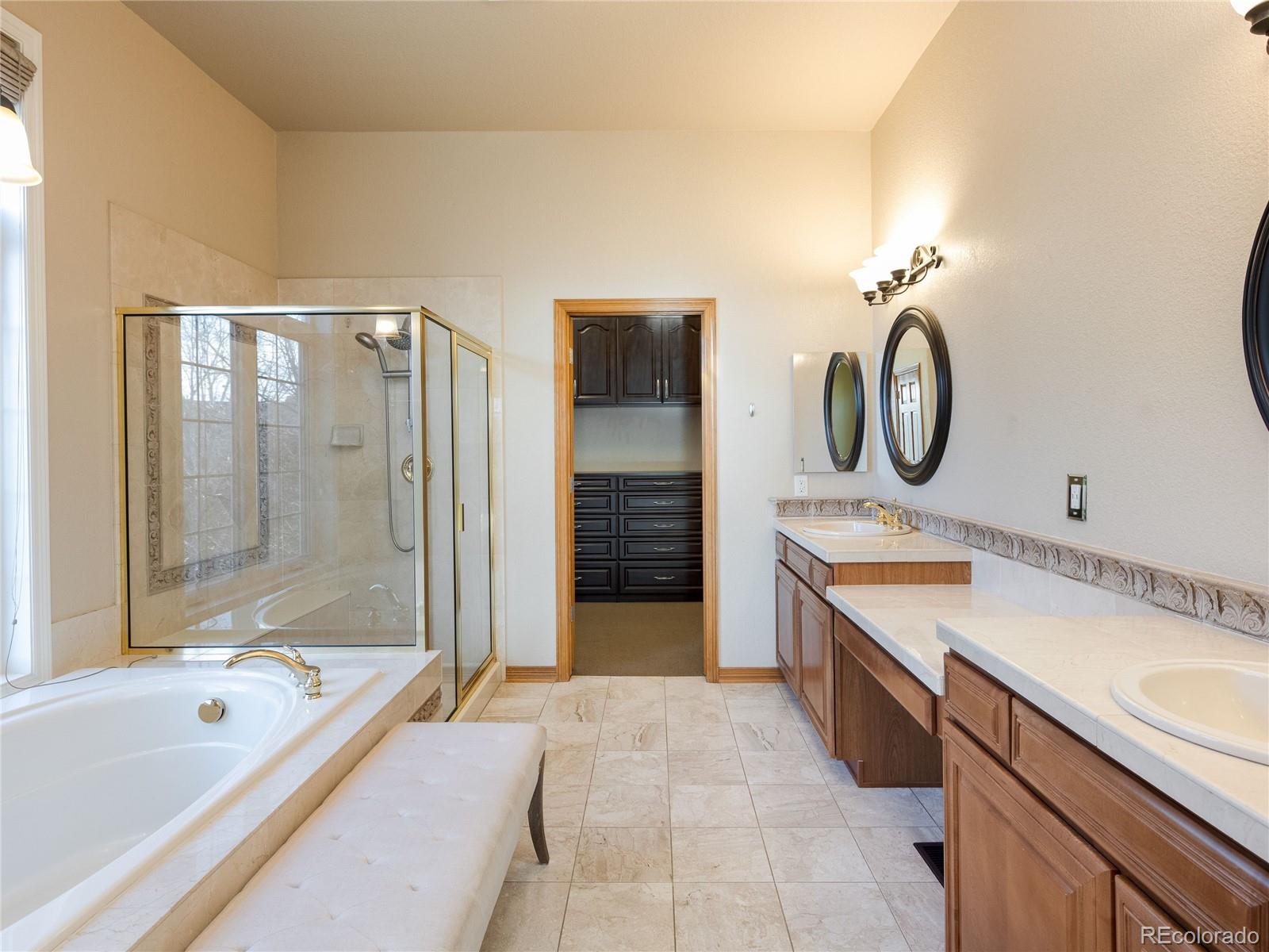 4940 West 107th Loop Westminster, CO 80031 - Photo 19 of 44 a spacious bathroom with a tub sink shower and mirror