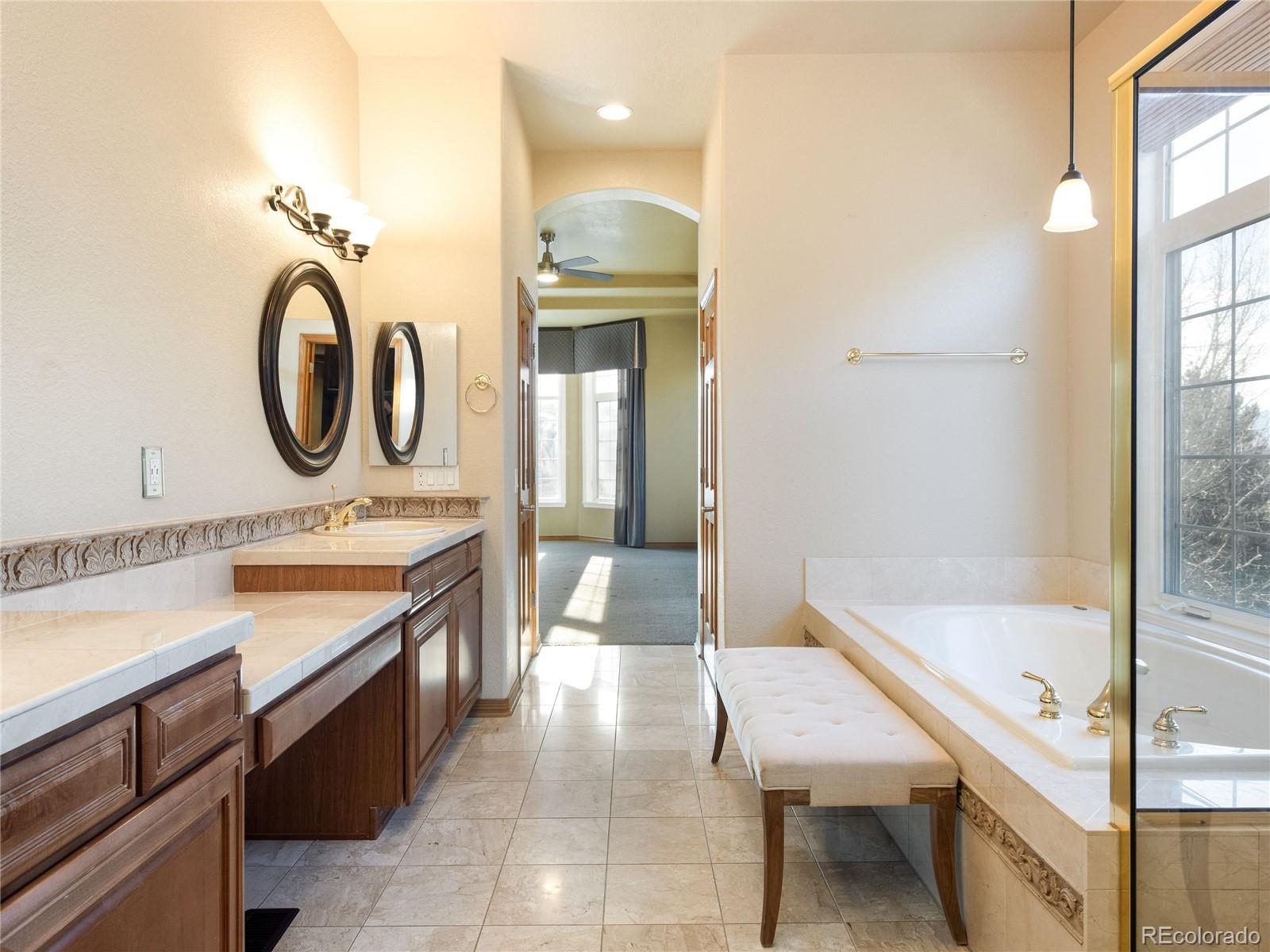 4940 West 107th Loop Westminster, CO 80031 - Photo 20 of 44 a bathroom with a sink a toilet and bathtub