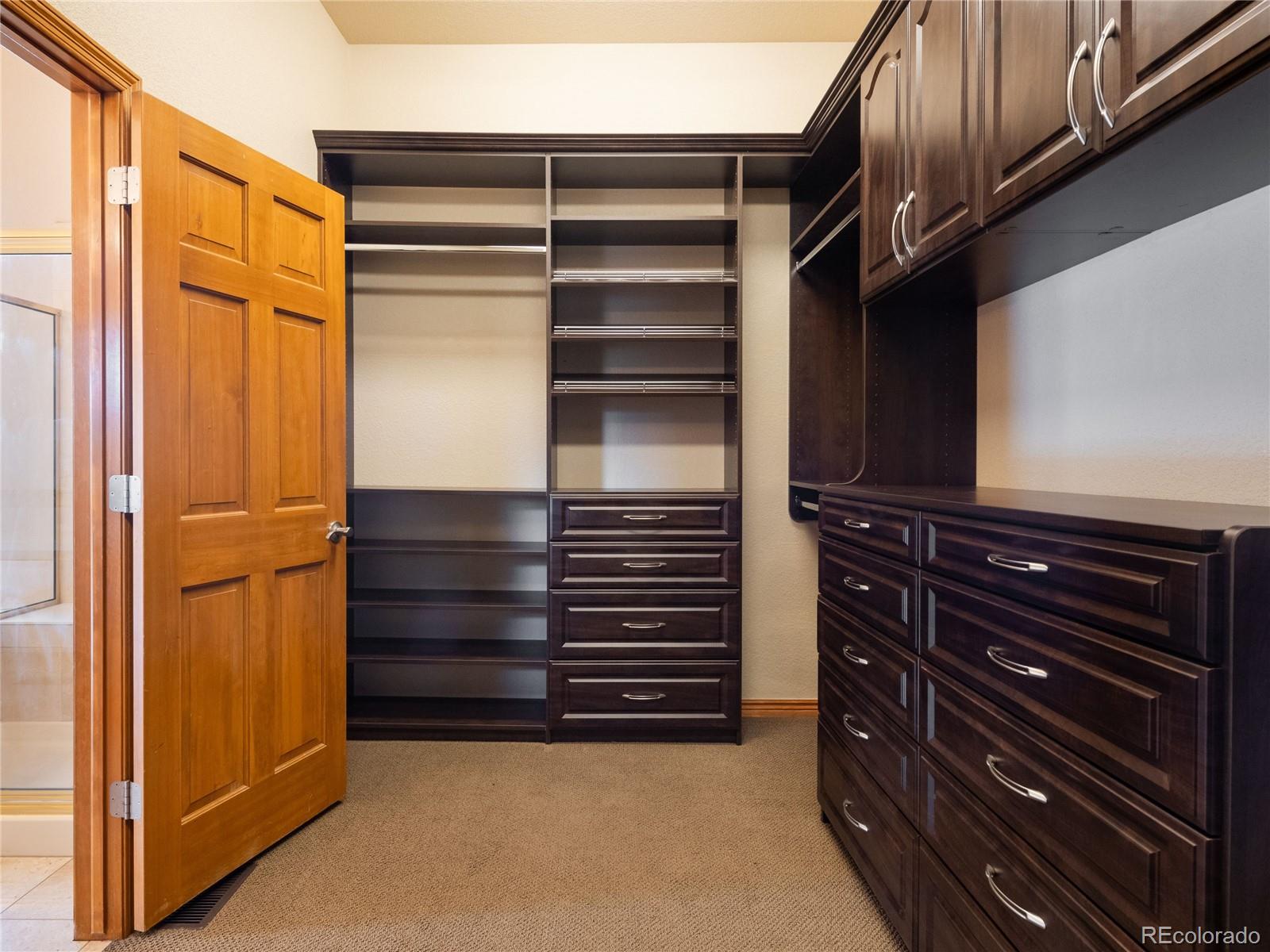 4940 West 107th Loop Westminster, CO 80031 - Photo 22 of 44 a view of walk in closet with clothes