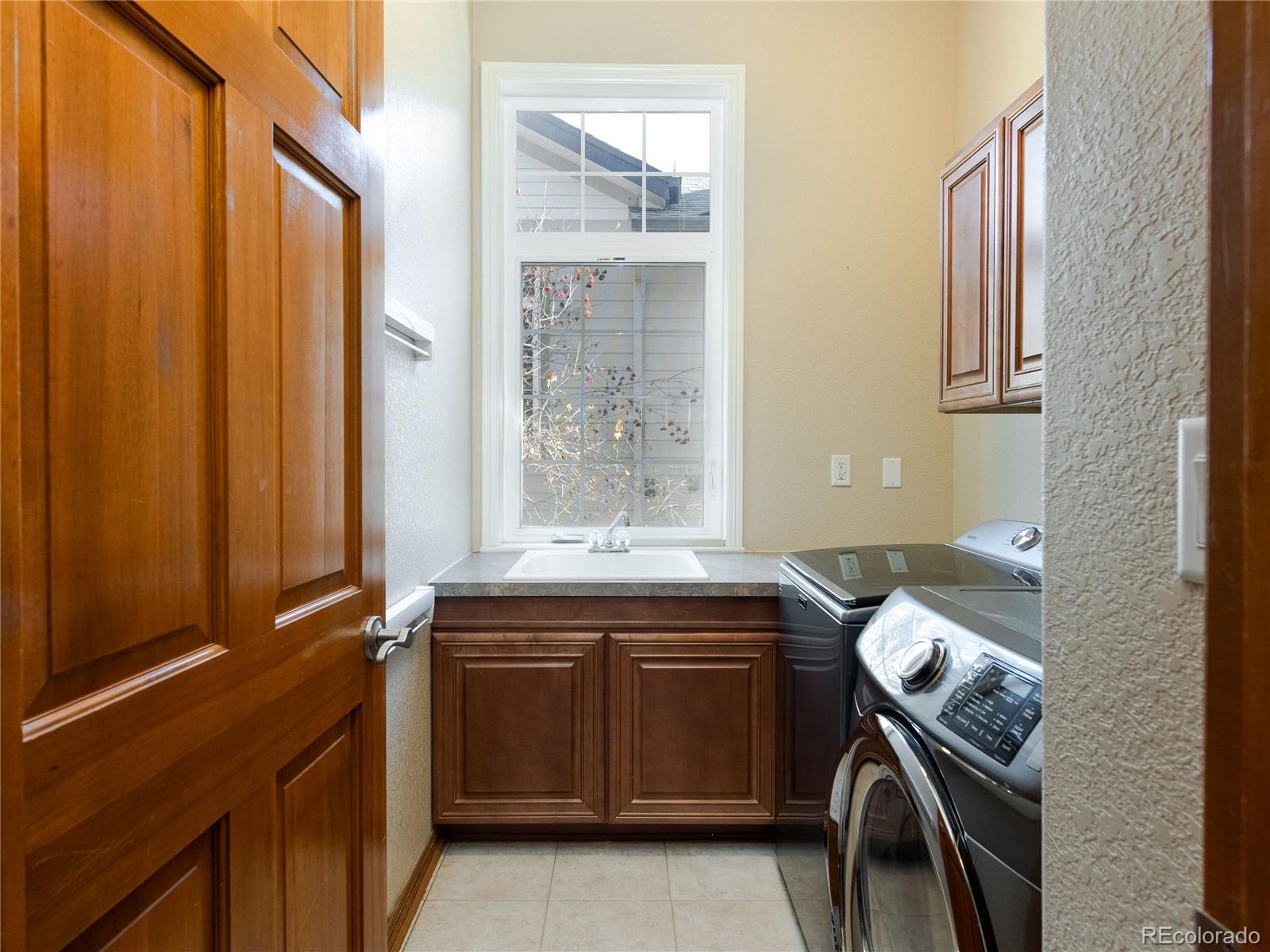 4940 West 107th Loop Westminster, CO 80031 - Photo 27 of 44 a utility room with a sink dryer and washer