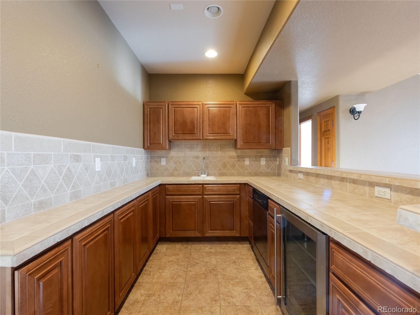 4940 West 107th Loop Westminster, CO 80031 - Photo 29 of 44 a kitchen with a sink and cabinets