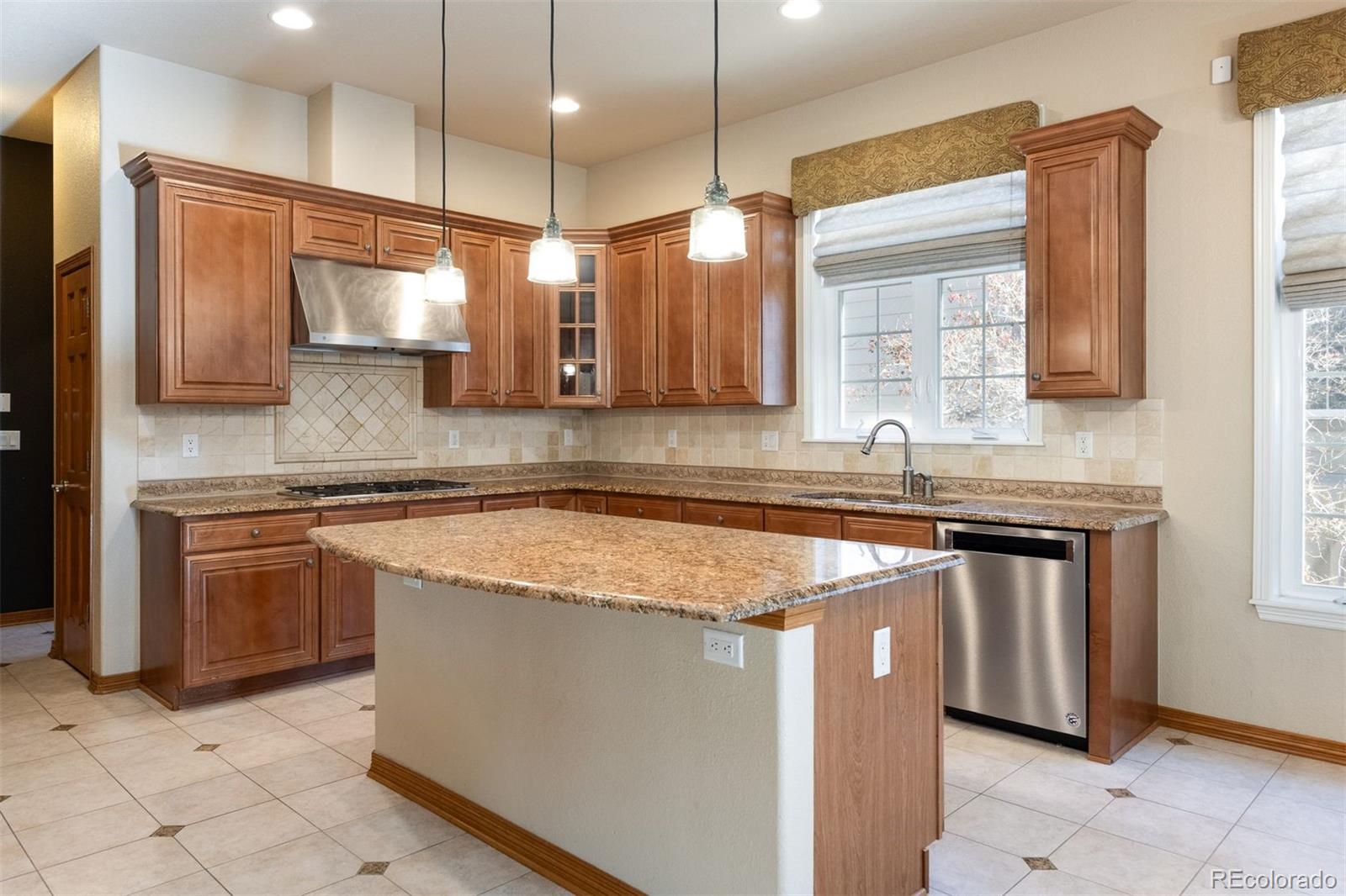 4940 West 107th Loop Westminster, CO 80031 - Photo 3 of 44 a kitchen with stainless steel appliances granite countertop a sink a stove and a microwave