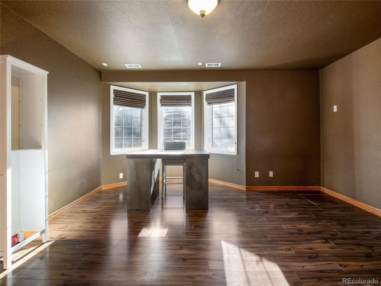 4940 West 107th Loop Westminster, CO 80031 - Photo 32 of 44 a view of an empty room with wooden floor and a window