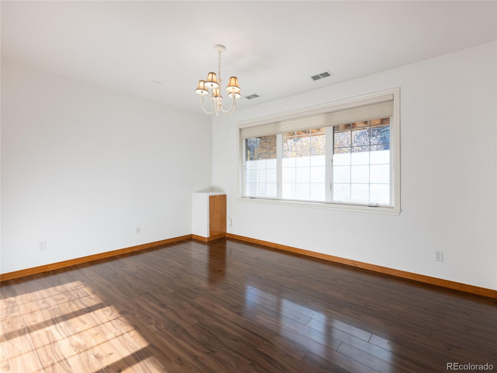 4940 West 107th Loop Westminster, CO 80031 - Photo 35 of 44 a view of an empty room with wooden floor and a window