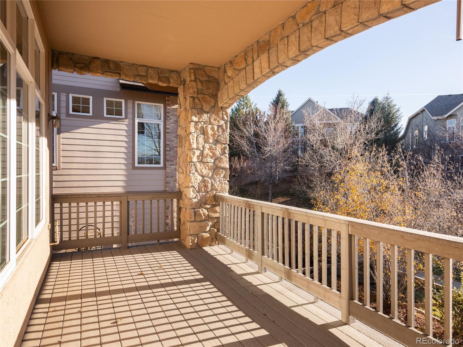 4940 West 107th Loop Westminster, CO 80031 - Photo 37 of 44 a view of a balcony with wooden floor and fence