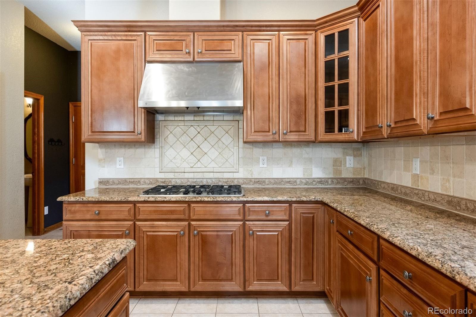 4940 West 107th Loop Westminster, CO 80031 - Photo 4 of 44 a kitchen with granite countertop cabinets and window