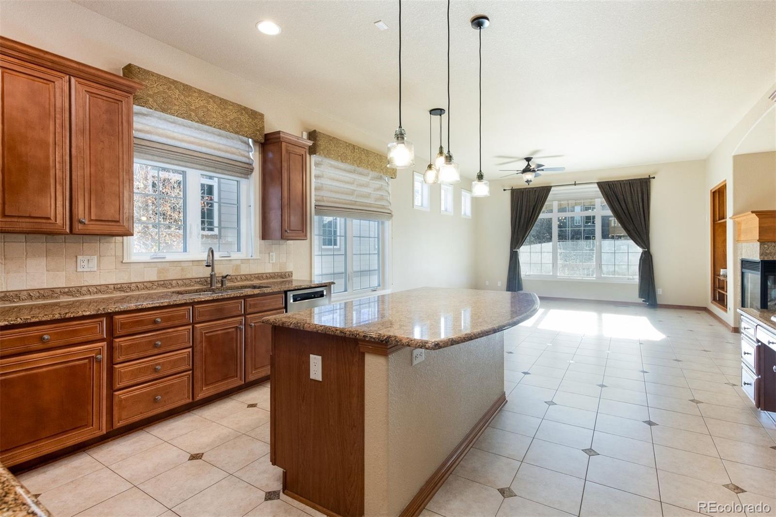 4940 West 107th Loop Westminster, CO 80031 - Photo 6 of 44 a kitchen with sink cabinets and window