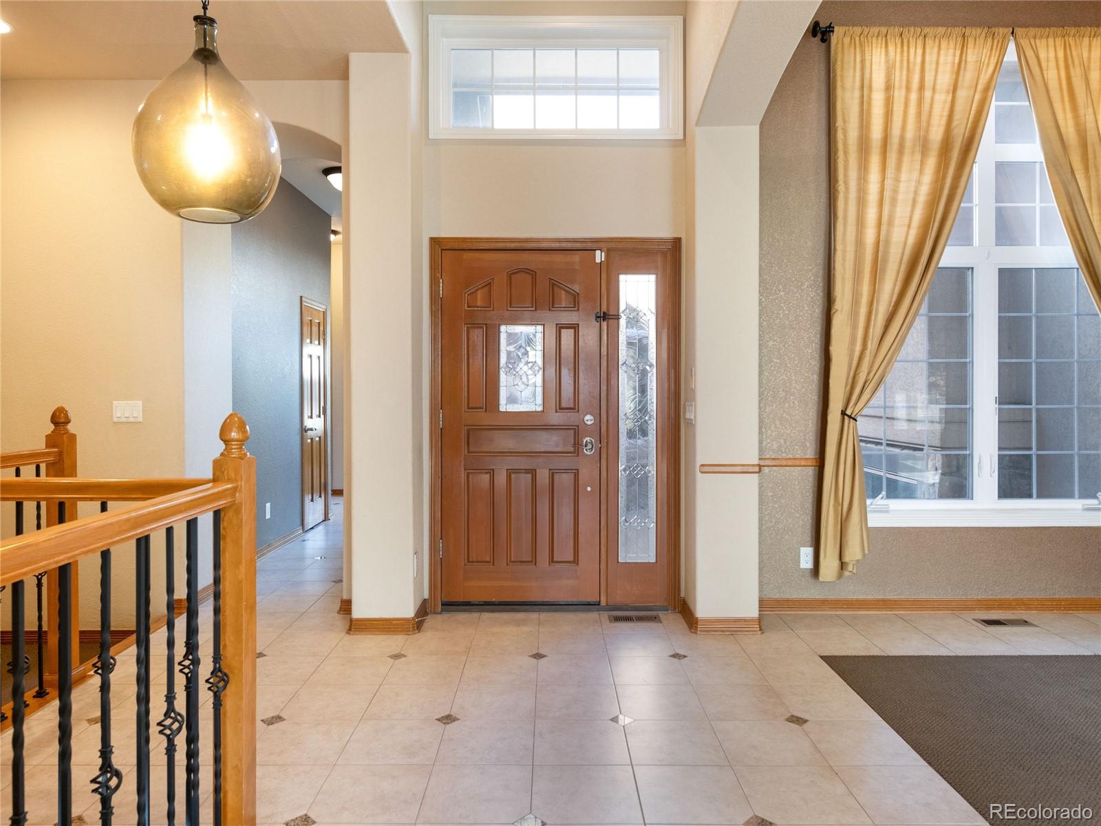 4940 West 107th Loop Westminster, CO 80031 - Photo 8 of 44 a view of a hallway with wooden floor and entryway