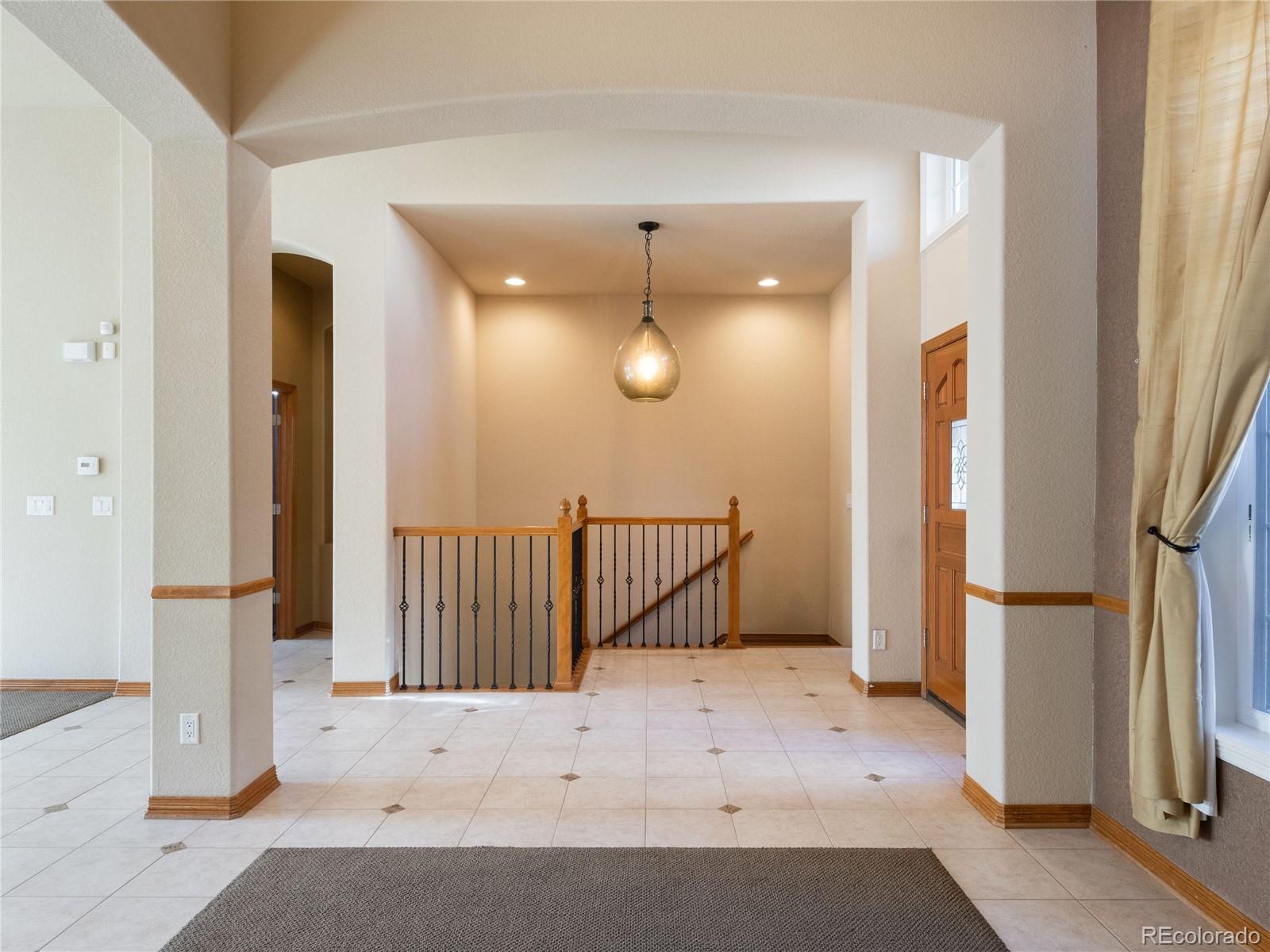 4940 West 107th Loop Westminster, CO 80031 - Photo 9 of 44 a view of entryway with wooden floor