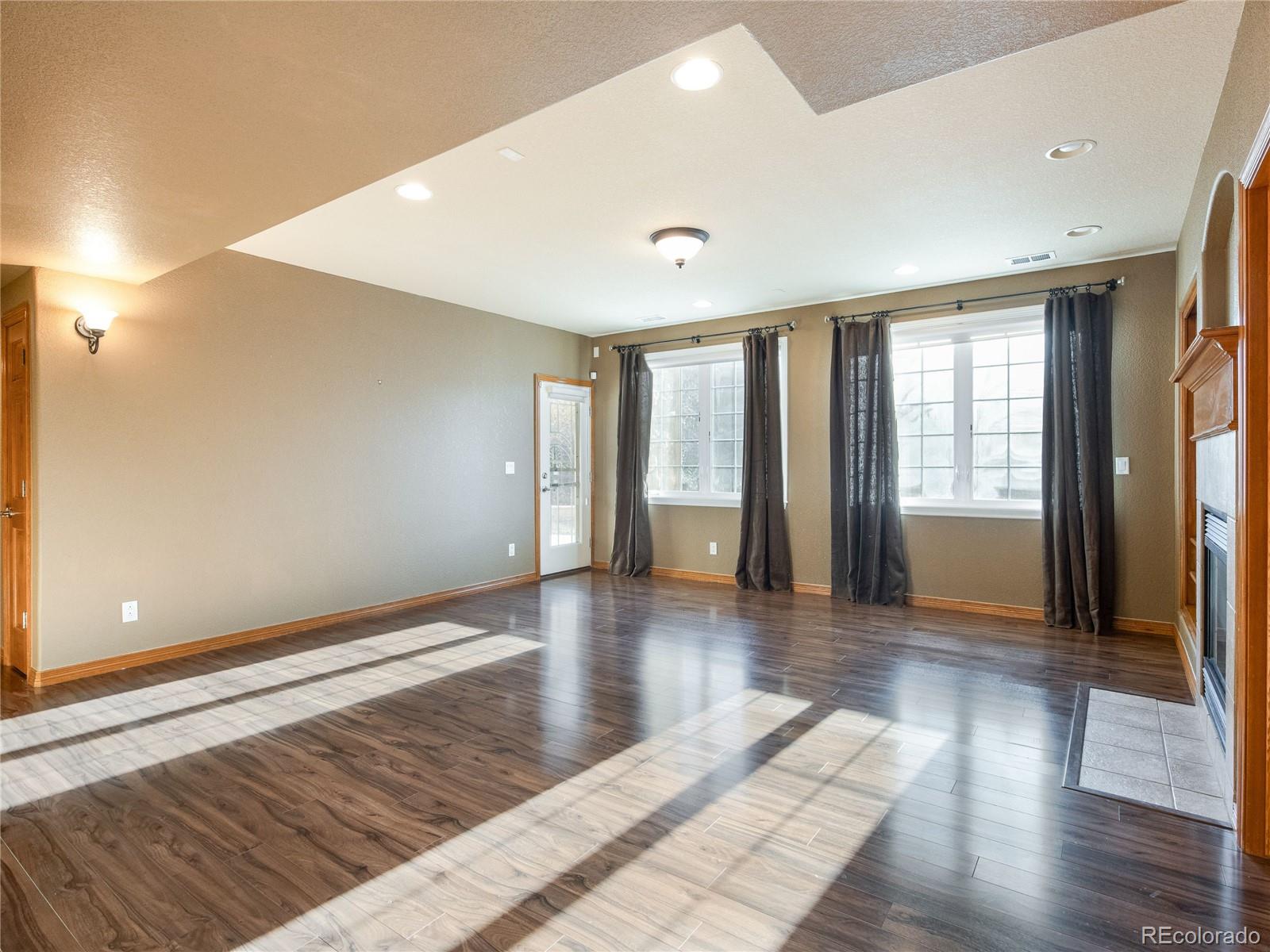 4940 West 107th Loop Westminster, CO 80031 - Photo 10 of 44 a view of an empty room with wooden floor and a window