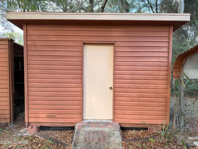 a kitchen with a large window in it and outdoor seating
