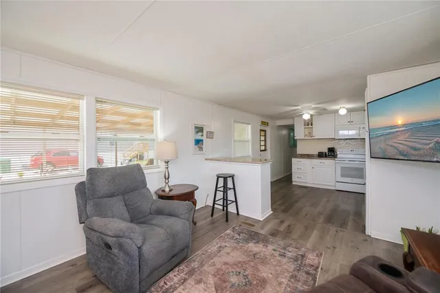 a bedroom with a bed and a chandelier fan