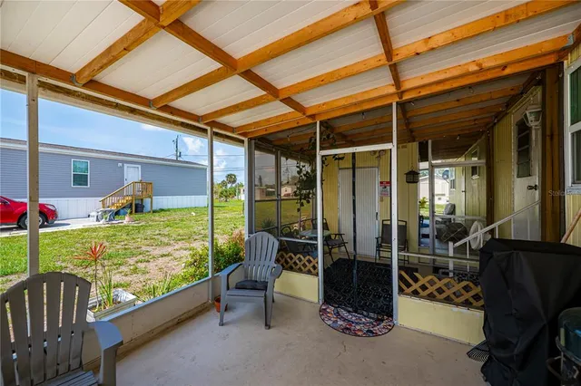 a view of a porch with furniture and garden