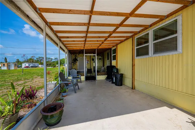 a view of an chairs and table in the patio