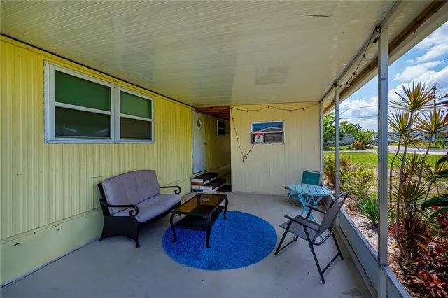 a view of a big yard with an outdoor seating