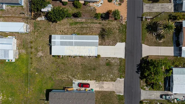 a view of yard with swimming pool and green space