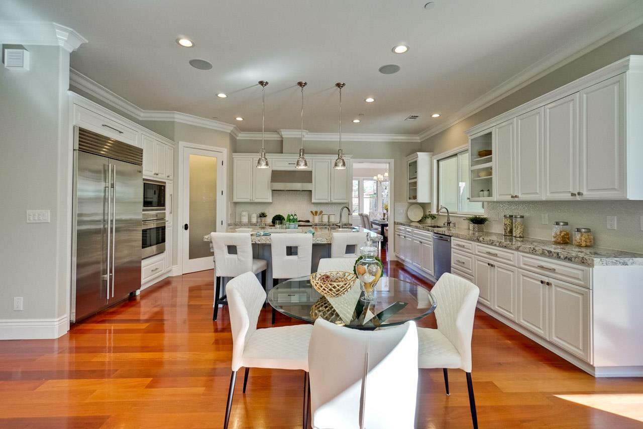 1650 Crestview Drive Los Altos, CA 94024 - Photo 16 of 50 a kitchen with stainless steel appliances kitchen island granite countertop a dining table chairs and view living room