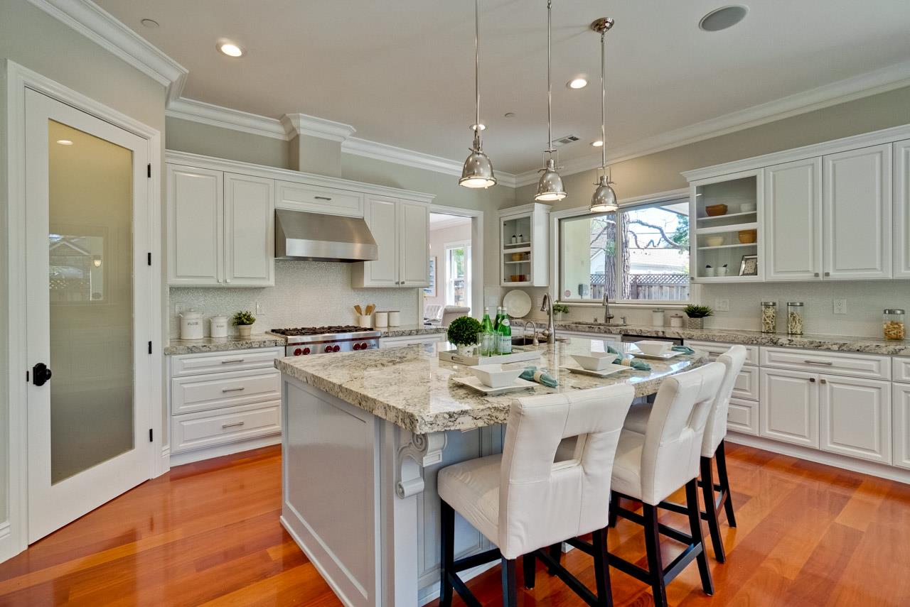 1650 Crestview Drive Los Altos, CA 94024 - Photo 17 of 50 a kitchen with kitchen island granite countertop a sink a counter space appliances and cabinets