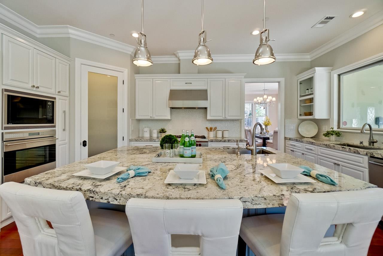1650 Crestview Drive Los Altos, CA 94024 - Photo 23 of 50 a kitchen with granite countertop kitchen island white cabinets and refrigerator