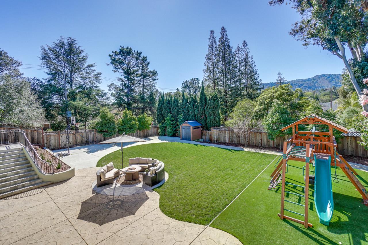 1650 Crestview Drive Los Altos, CA 94024 - Photo 4 of 50 a view of a swimming pool with a garden and plants