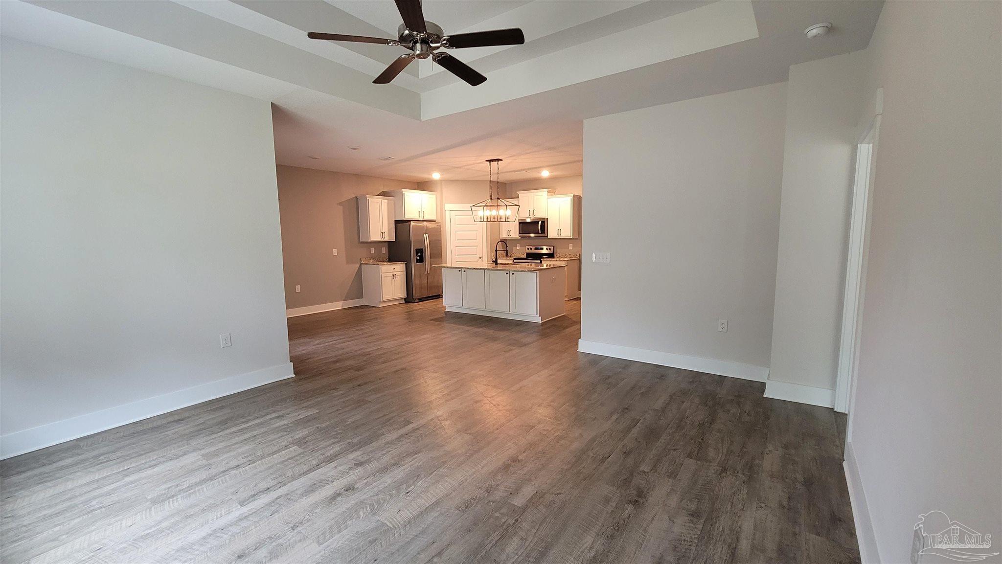 5748 Conley Court Pace, FL 32571 - Photo 11 of 22 a view of a kitchen with a sink a ceiling fan and wooden floor