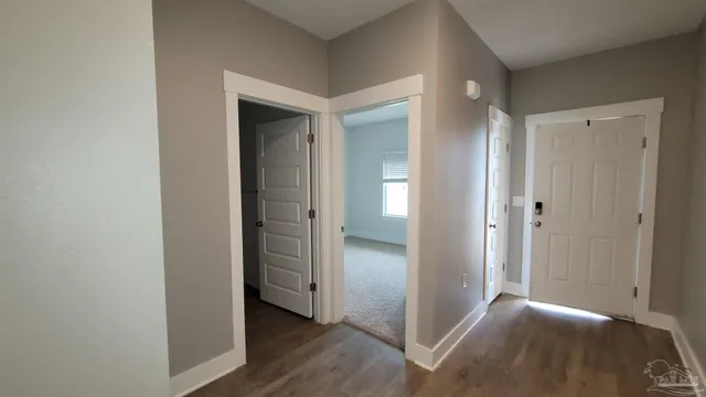 a view of hallway with wooden floor