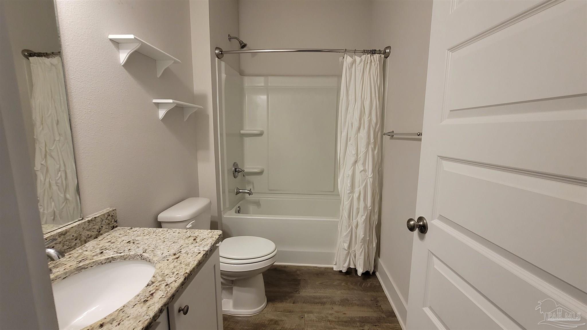 5748 Conley Court Pace, FL 32571 - Photo 16 of 22 a bathroom with a granite countertop sink toilet and shower