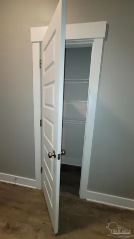 an empty room with wooden floor and white wall