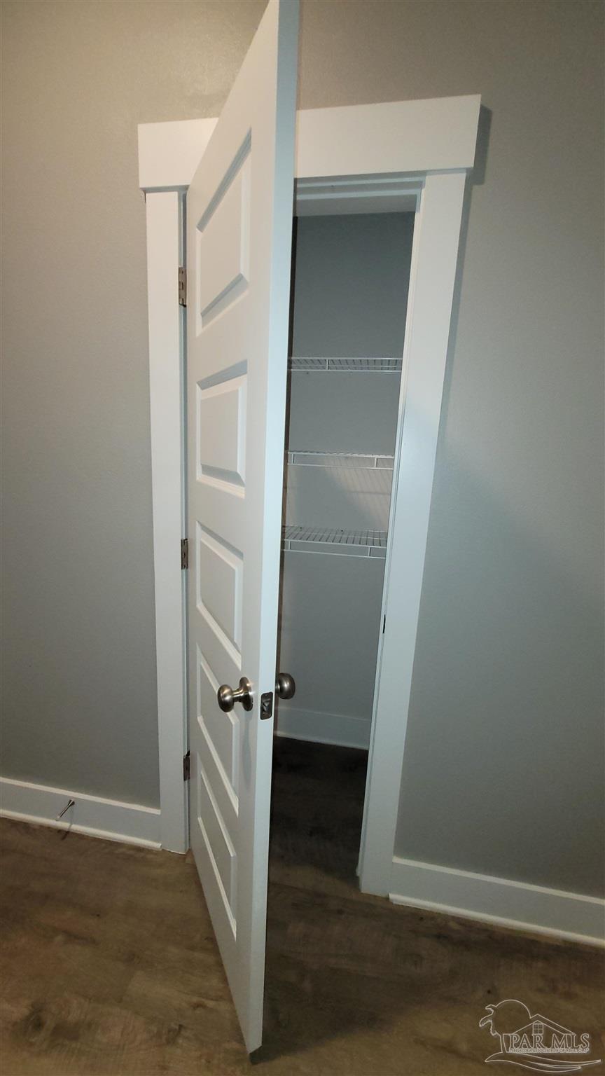 5748 Conley Court Pace, FL 32571 - Photo 17 of 22 an empty room with wooden floor and white wall