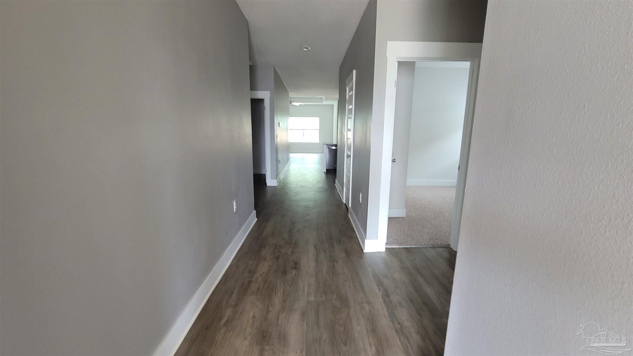 5748 Conley Court Pace, FL 32571 - Photo 5 of 22 a view of a hallway with wooden floor
