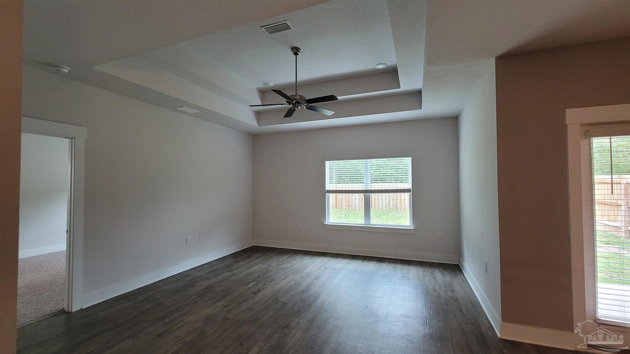 5748 Conley Court Pace, FL 32571 - Photo 10 of 22 an empty room with wooden floor windows and fan