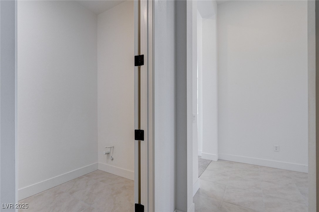 4992 Ascent Point Las Vegas, NV 89135 - Photo 49 of 61 Hallway featuring baseboards and light tile patterned floors