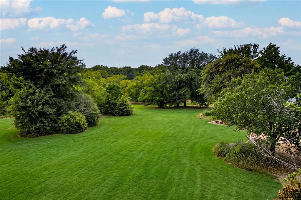 4571 Running Branch Road Aubrey, TX 76227 - Photo 6 of 26 Expansive green lawn surrounded by mature trees and natural landscaping