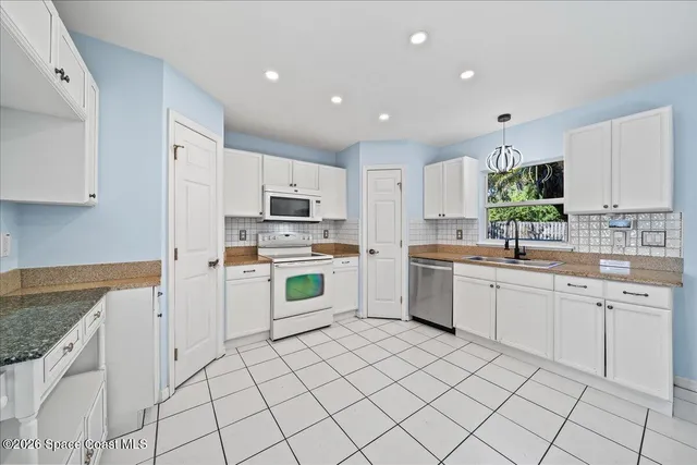 a living room with furniture a refrigerator and a stove top oven