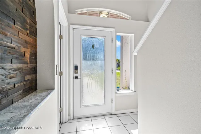 a view of entryway with wooden floor and stairs