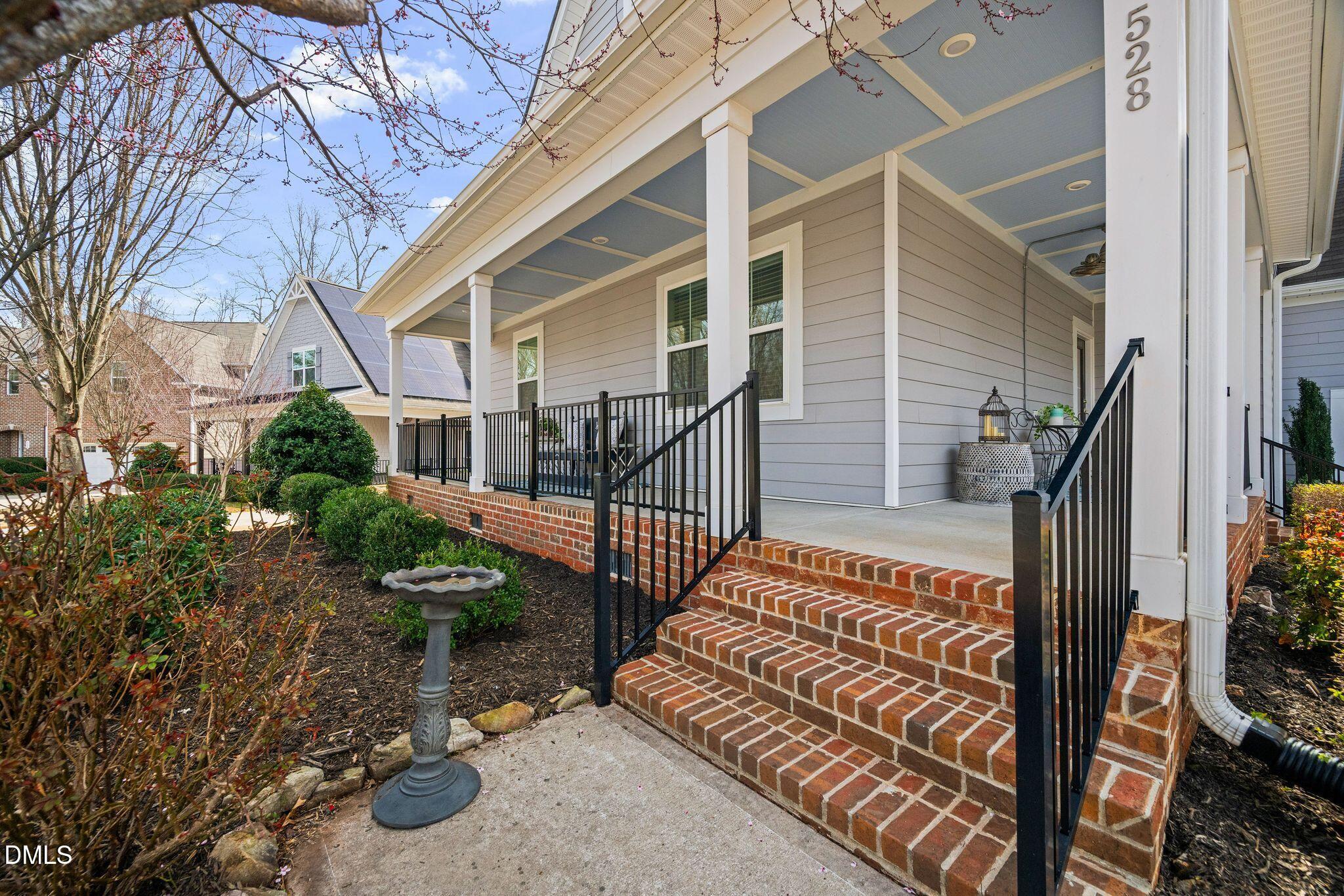 528 Spring Flower Court Cary, NC 27511 - Photo 2 of 51 a view of house with wooden deck and a forest