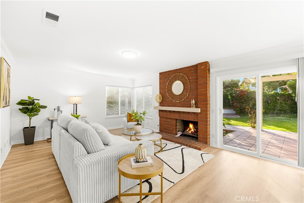 19 Alameda Irvine, CA 92620 - Photo 13 of 59 a living room with furniture a fireplace and a floor to ceiling window