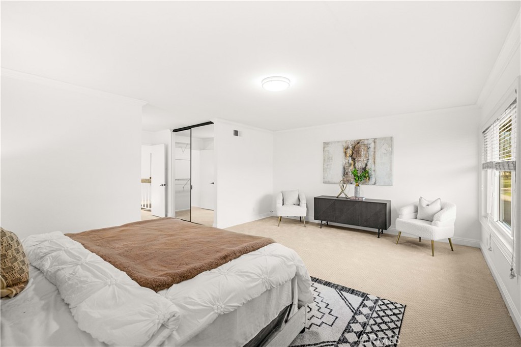 19 Alameda Irvine, CA 92620 - Photo 23 of 59 a spacious bedroom with a bed a couch and a window