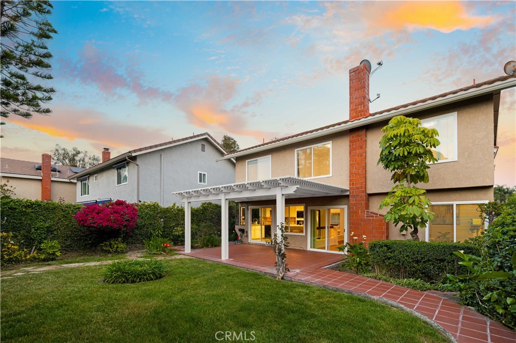 19 Alameda Irvine, CA 92620 - Photo 43 of 59 a front view of a house with a yard and outdoor seating
