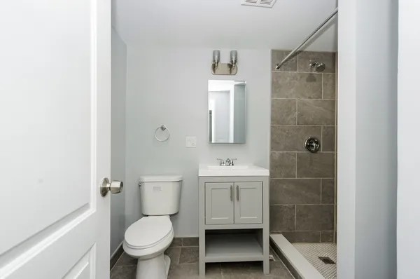 a bathroom with a toilet a sink and shower
