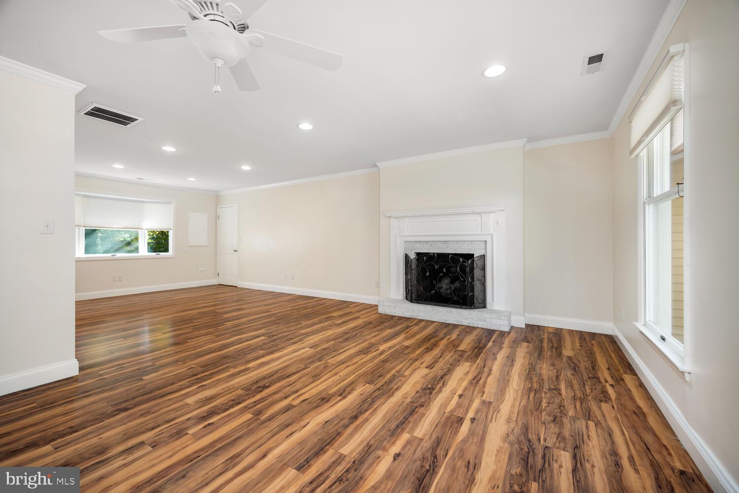 29202 Holly Road Easton, MD 21601 - Photo 11 of 34 a view of an empty room with wooden floor fireplace and a window