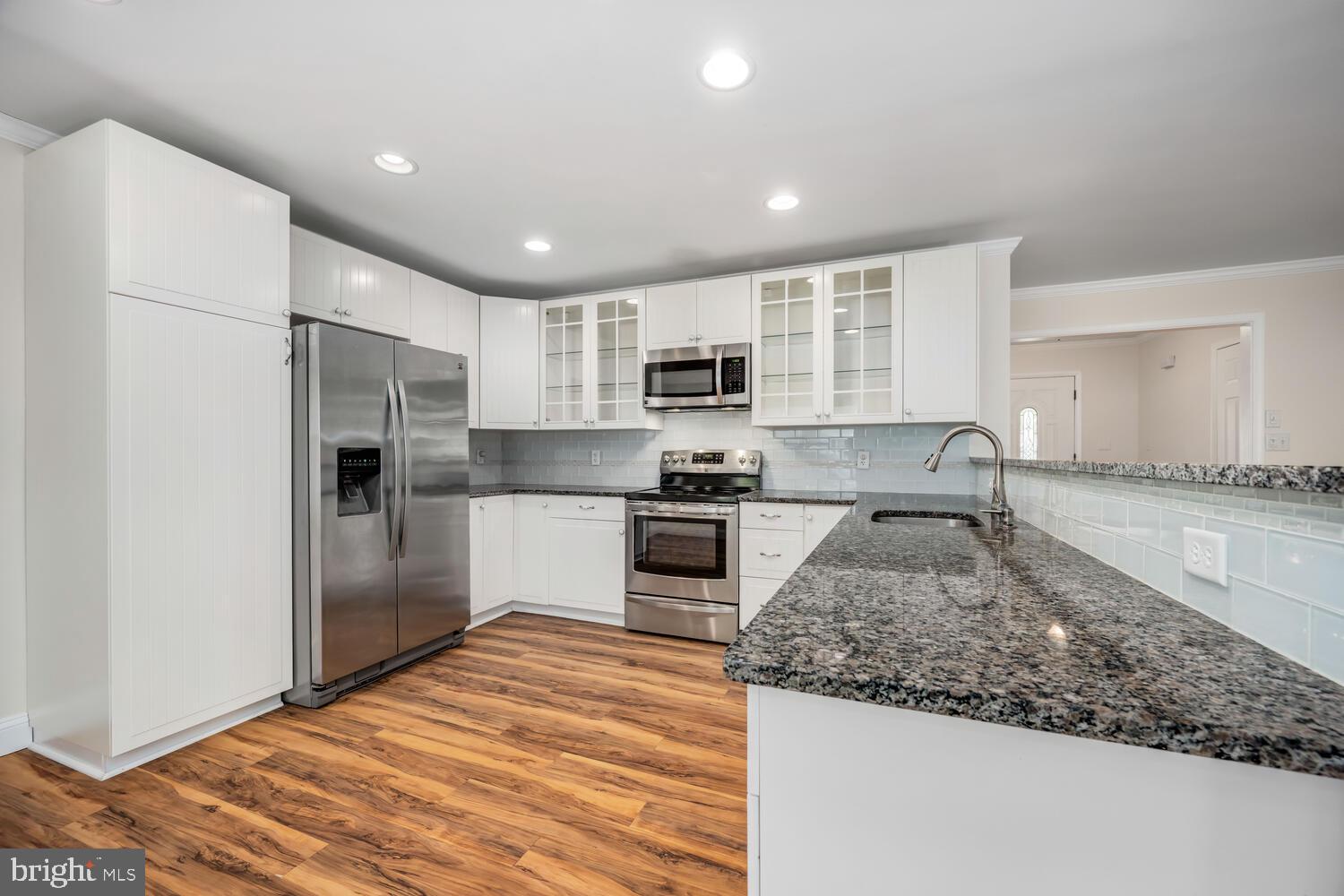 29202 Holly Road Easton, MD 21601 - Photo 16 of 34 a kitchen with stainless steel appliances granite countertop a refrigerator sink and stove