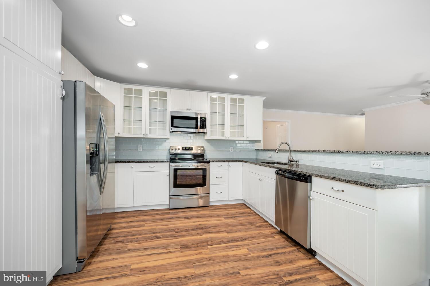 29202 Holly Road Easton, MD 21601 - Photo 17 of 34 a kitchen with kitchen island granite countertop appliances cabinets and a sink
