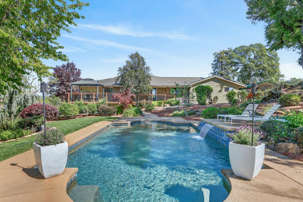 5560 Ralston Way Placerville, CA 95667 - Photo 1 of 78 Expansive backyard featuring a custom pool with waterfall and garden with mature landscaping