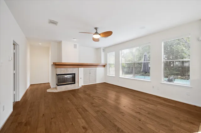 a living room with furniture fireplace and a large window