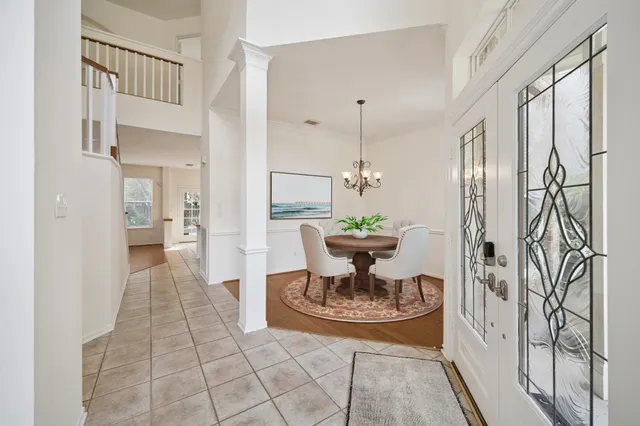 a view of dining room and kitchen with furniture wooden floor and a chandelier
