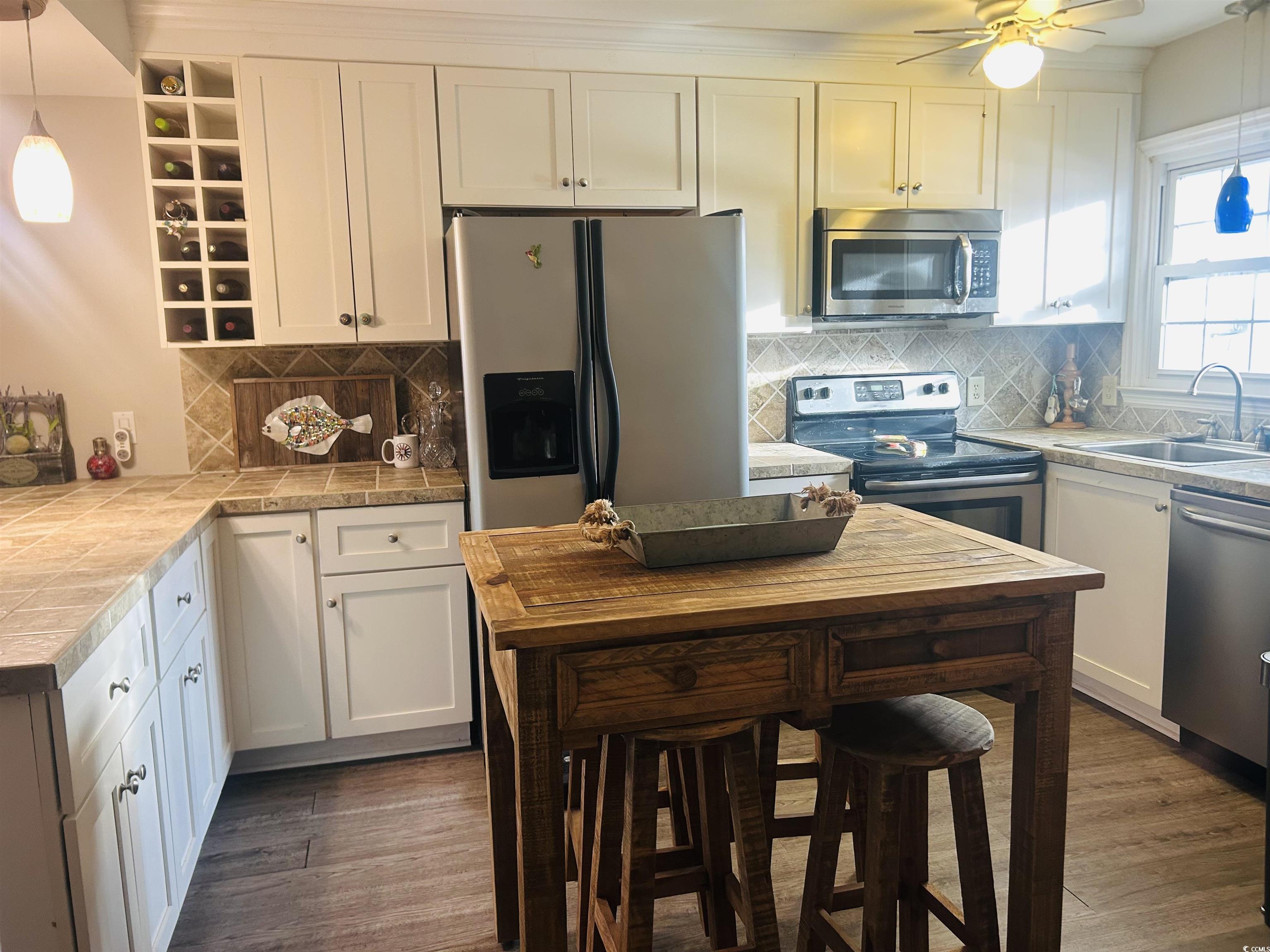3866 Highway 17 Business, Unit C3 Murrells Inlet, SC 29576 - Photo 6 of 32 Kitchen featuring dark hardwood / wood-style floors, pendant lighting, white cabinetry, sink, and stainless steel appliances