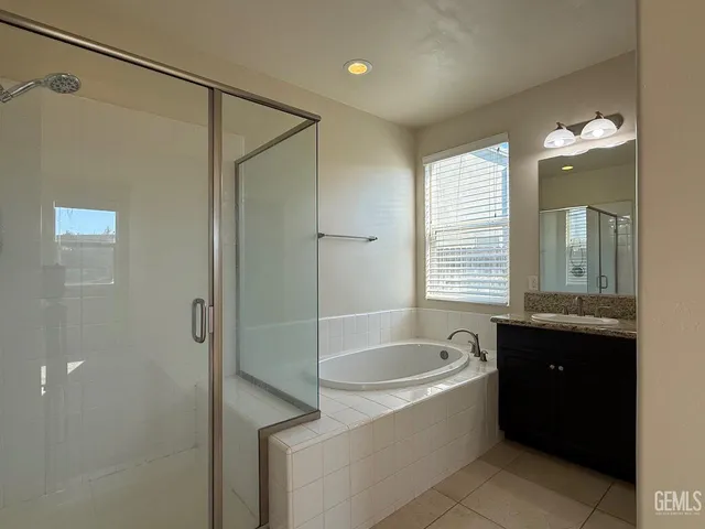 a spacious bathroom with a bathtub and a shower